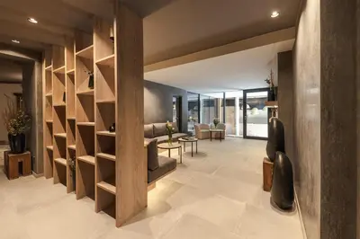 a lobby with wooden shelves and a living room at Avidea - Adults Only in Lagundo