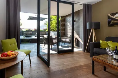 a living room with a table and a dining room at Avidea - Adults Only in Lagundo