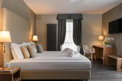a hotel room with a bed and a window at X Alp Hotel in Pozza di Fassa