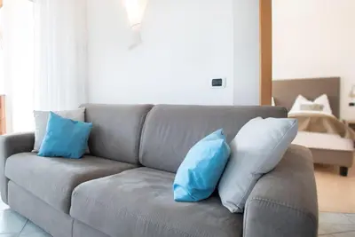 two blue and white pillows sitting on a couch at Residence Roland in Caldaro