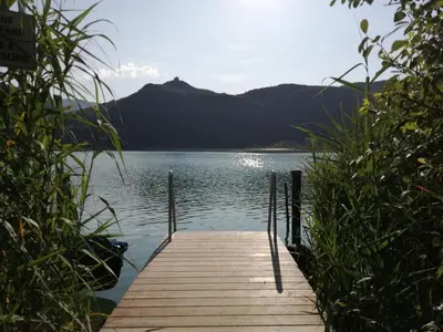 a wooden dock sitting on top of a body of water at Residence Roland in Caldaro