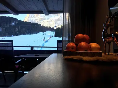 a bowl of oranges on a table with a view of a mountain at Chalet Albric in Selva di Val Gardena