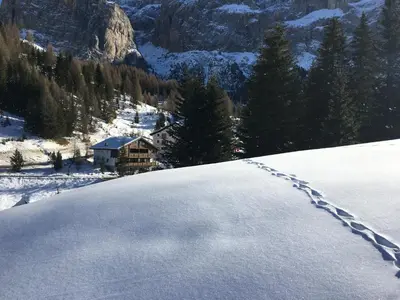 a pile of snow with a trail in the distance at Chalet Albric in Selva di Val Gardena
