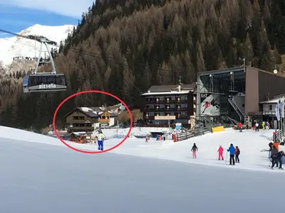 a group of people in the snow next to a ski lift at Chalet Albric in Selva di Val Gardena