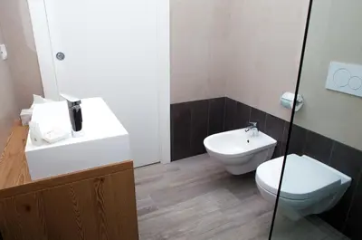 a bathroom with a toilet and a sink at Loft 82 Apartments in Bolzano