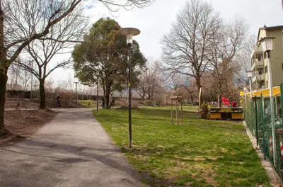 a street light in a park next to a sidewalk at Loft 82 Apartments in Bolzano