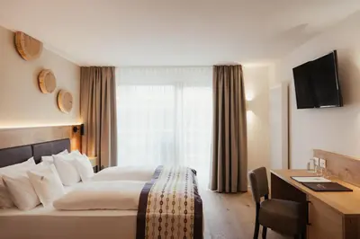 a hotel room with a bed and a desk at Hotel Diamant in San Cassiano