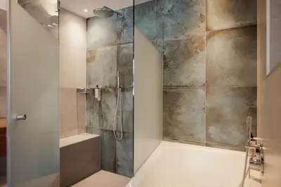 a shower with a glass door in a bathroom at Hotel Diamant in San Cassiano