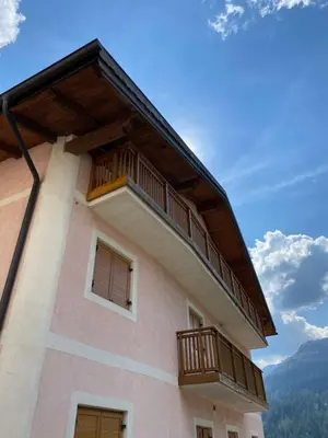 a building with two balconies on the side of it at Casa Fiemme Panchià in Panchia