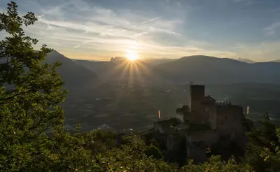 a view of the sun setting over a city at Haus Winkler in Vilpiano