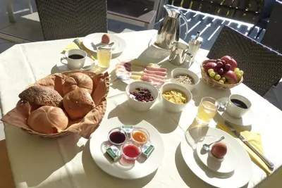 a table topped with plates of food and fruit at Haus Winkler in Vilpiano