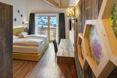 a hotel room with two beds and a window at Plang Farmhouse in San Cassiano