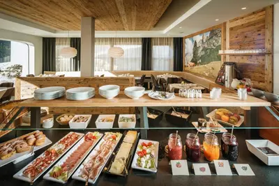 a buffet line with food on display in a restaurant at Plang Farmhouse in San Cassiano