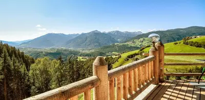 a balcony with a view of a valley with mountains at Chalet Flierer in Rodengo