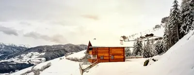 a wooden cabin in the snow on a mountain at Chalet Flierer in Rodengo