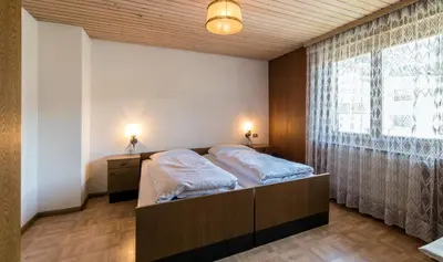 a bedroom with a bed and a large window at Residence Trametsch in Bressanone