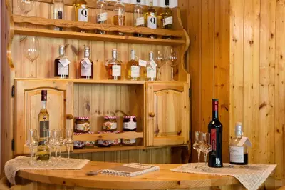 a room with bottles of wine and glasses on a table at GH Hotel Piaz in Pozza di Fassa