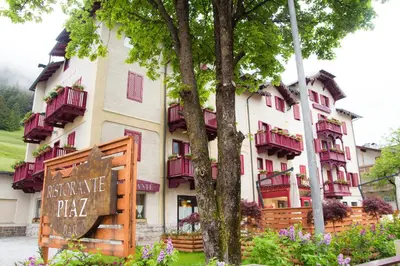 a large building with a sign in front of it at GH Hotel Piaz in Pozza di Fassa