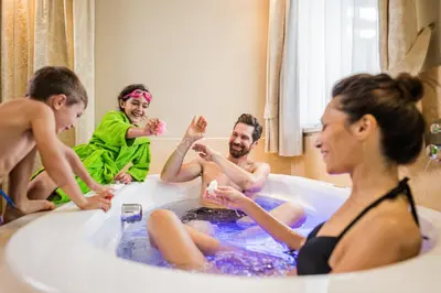 a group of people in a bath tub at Hotel Fameli in Valdaora