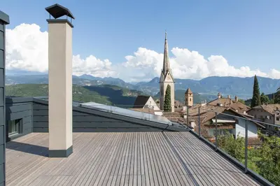 a roof with a view of a town and a church at Villa KaTo in Caldaro