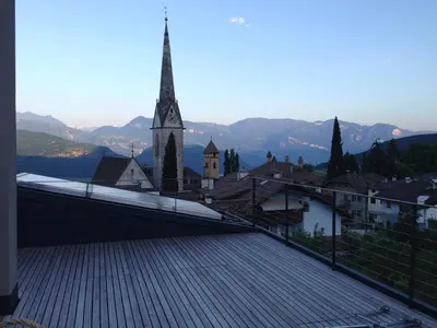a view of a town with a clock tower at Villa KaTo in Caldaro