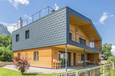 a house with a metal roof on top of it at Villa KaTo in Caldaro