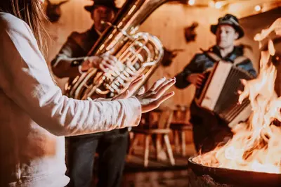 a woman playing a saxophone and a man playing a accordion at Hotel Bergschlössl in Luson