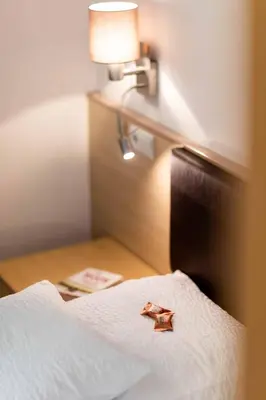 a star on a bed in a hotel room at Pixner Apartments in Bolzano