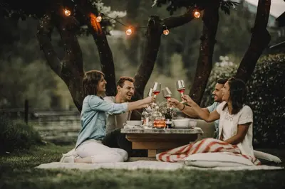 a group of people sitting around a table drinking wine at Farmhouse Torgglerhof in Saltusio