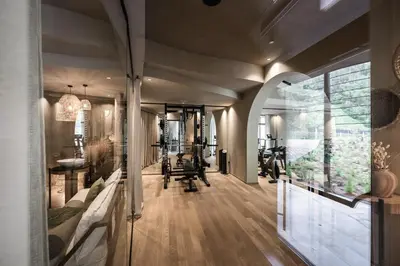 a gym with multiple treadmills and machines in a room at Farmhouse Torgglerhof in Saltusio