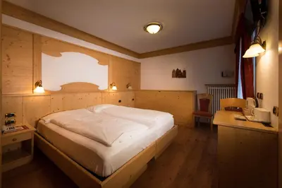 a bathroom with a sink and a toilet and a shower at Hotel Zirmes in Moena