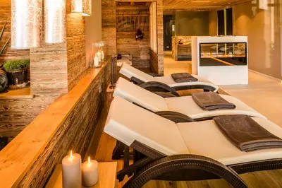 a row of chairs in a restaurant with candles at Hotel Am Sonneck in Lagundo