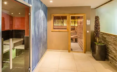 a hallway with a door leading into a room with at Hotel Am Sonneck in Lagundo