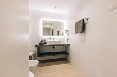 a white bathroom with a sink and a toilet at Residence Martinelli in Laives