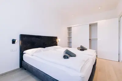 a bedroom with a large white bed with two pillows on it at Residence Martinelli in Laives