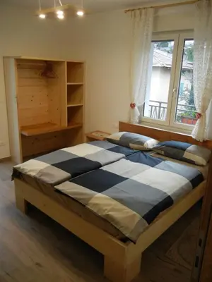 a bedroom with two beds and a window at B&B RAINA in Castelfondo