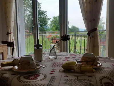 a table with a table cloth on a table with a window at B&B RAINA in Castelfondo