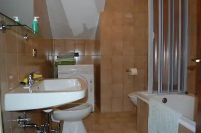 a bathroom with a white sink and a toilet at Mountain in Alleghe