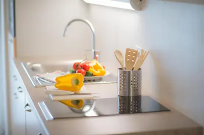 a kitchen counter with a sink and a counter top with utensils at Grabmayrhof in Termeno