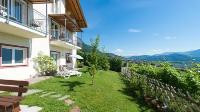 a house with a garden with a view of the mountains at Grabmayrhof in Termeno