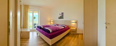 a bedroom with a purple bed in a room at Grabmayrhof in Termeno