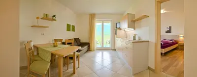 a kitchen and a dining room with a table at Grabmayrhof in Termeno
