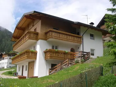 two beds sitting next to each other in a room at Cèsa Chri e Sofì in Campitello di Fassa