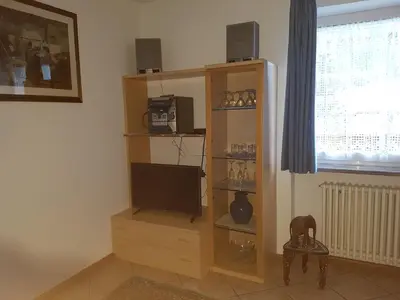 a bedroom with a bed and a desk with a computer at Cèsa Chri e Sofì in Campitello di Fassa