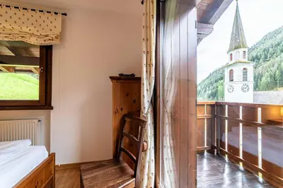 a house with wooden balconies on the side of it at Dolomites Dream Arabba in Livinallongo del Col di Lana