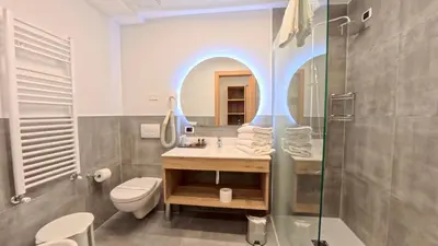 a bathroom with a sink and a shower at Hotel Cristallo in Canazei