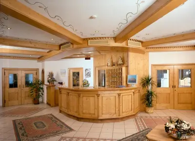 a large room with a large wooden trial courtroom at Hotel Cristallo in Canazei