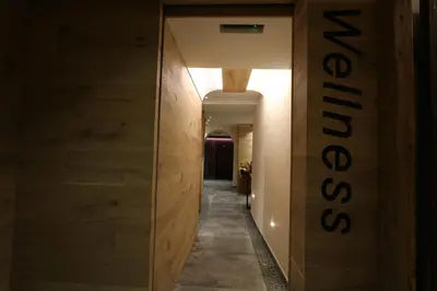 a long hallway with a sign on the wall at Hotel Fonte Dei Veli in Panchia