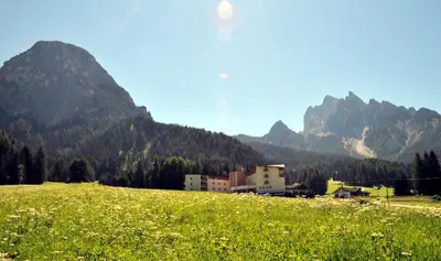 a banquet hall with tables and chairs and tablesearcher at Hotel Asterbel in Braies