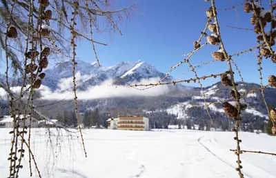 a view of a snow covered mountain in the distance at Hotel Asterbel in Braies
